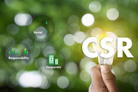 Image shows the letters CSR for Corporate Social Responsibility set against a leafy green backdrop