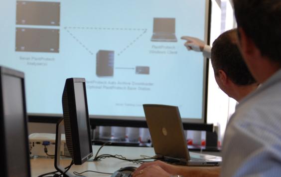 Engineers attending a conference viewing a presentation screen