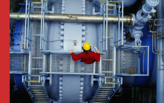 Shows Beran engineer on power station looking down over machinery